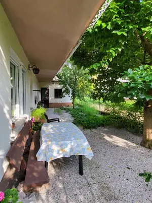 a patio with a table and benches on a house at Apartma Magdalena in Kobarid