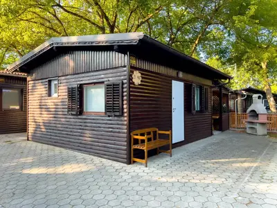 a small cabin with a bench in front of it at Hiška pod hrastom, G110 Podčetrtek, Aqualuna, Olimia in Podčetrtek