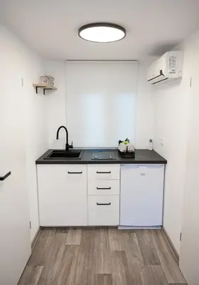 a kitchen with white cabinets and a sink at Hiška pod hrastom, G110 Podčetrtek, Aqualuna, Olimia in Podčetrtek