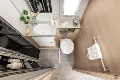 a small bathroom with a sink and a toilet at Camper GiottiLine Siena 385 in Šenčur