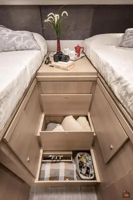 two beds with their drawers filled with towels at Camper GiottiLine Siena 385 in Šenčur