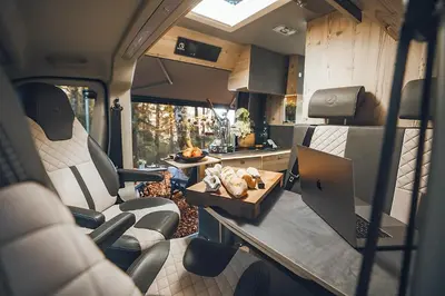 an interior view of an rv with a table and a laptop at Robeta Ares in Šenčur