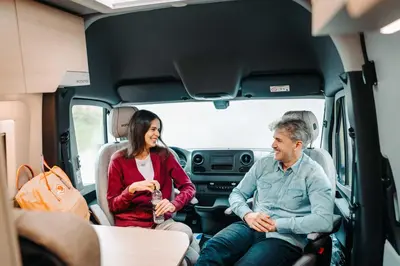 a man and a woman sitting in the back of a van at Robeta Ares in Šenčur