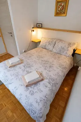 a bedroom with a bed with two books on it at Apartma Lina in Bovec