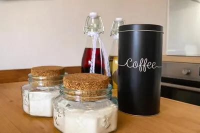 a table with three jars of condiments on it at Apartma Lina in Bovec