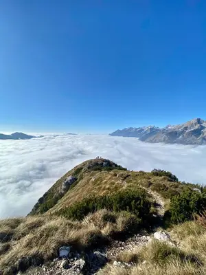 a group of people on top of a mountain with clouds at Apartma Lina in Bovec
