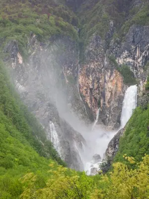 a waterfall on the side of a mountain at Apartma Lina in Bovec