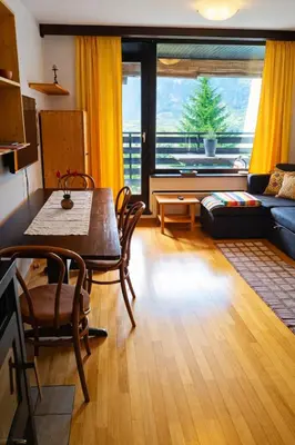 a living room with a table and a couch at Apartma Lina in Bovec