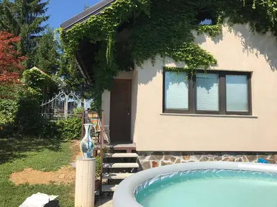 a house with a hot tub in front of it at Wine & Nature & Tour in Ptuj