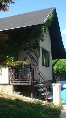 a house with a balcony with flowers on it at Wine & Nature & Tour in Ptuj