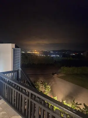 a balcony with a view of a city at night at Studio Vista apartment in Leskovec pri Krškem