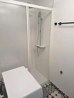 a white bathroom with a shower and a toilet at Studio Vista apartment in Leskovec pri Krškem