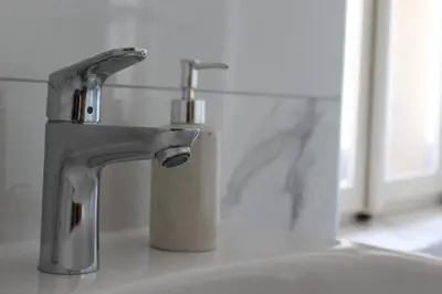 a white bathroom sink with a faucet at Grad Kojsko in Kojsko