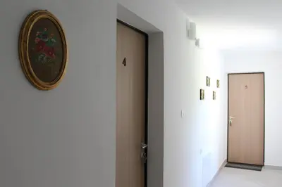 a hallway with a door and a clock on the wall at Grad Kojsko in Kojsko