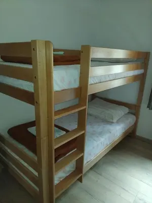 a couple of bunk beds in a room at Planinska koča na Kopitniku in Dol pri Hrastniku