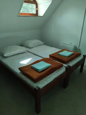 two beds in a room with two mats on them at Planinska koča na Kopitniku in Dol pri Hrastniku