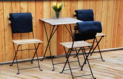 two chairs and a table with a vase of flowers at Hiša Plesnik in Solčava