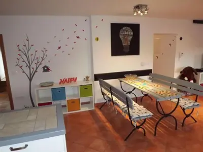 a living room with a table and a table and chairs at Velika Hiša in Rašica