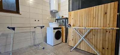 a laundry room with a washing machine and a washer at Apartments Dvor by the Krka river in Rove