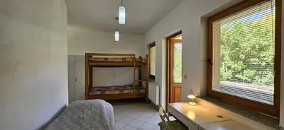a bedroom with a bunk bed and a window at Apartments Dvor by the Krka river in Rove