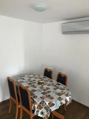a dining room table with chairs and a tablecloth on it at B&B Rot in Bohinjska Bela