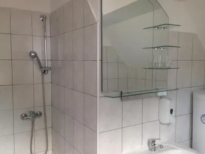 a bathroom with a shower with a mirror and a sink at B&B Rot in Bohinjska Bela