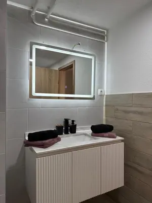 a bathroom with a white sink and a mirror at Piece of Heaven in Zgornje Gorje