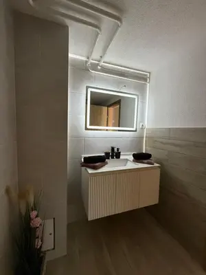 a bathroom with a sink and a mirror at Piece of Heaven in Zgornje Gorje