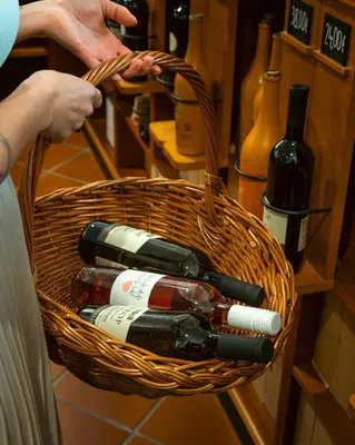 a basket full of wine bottles on a counter at Dvorec Jeruzalem in Ivanjkovci