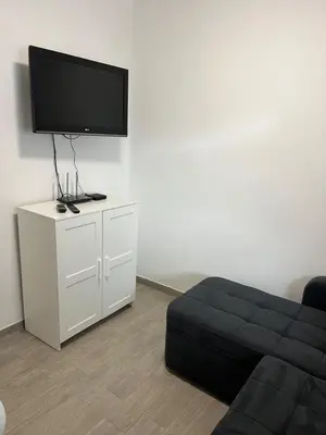 a living room with a couch and a flat screen tv at Apartma GoDeTi in Rečica ob Savinji