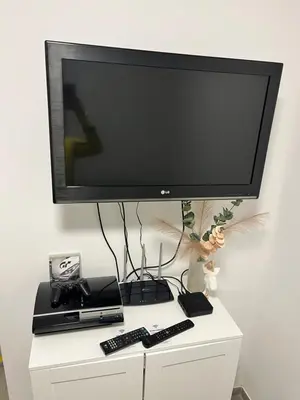a flat screen tv sitting on top of a white cabinet at Apartma GoDeTi in Rečica ob Savinji