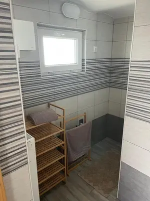 a small bathroom with a shower with a window at Apartma GoDeTi in Rečica ob Savinji