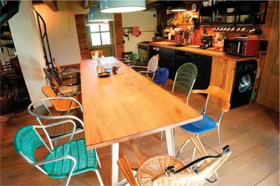 a large wooden table and chairs in a kitchen at Apartment Tlaka in Gornji Grad