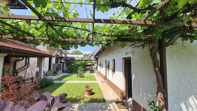 an outside view of a house with a yard at Brne Family House in Postojna