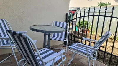 a table and four chairs and a table and a fence at Brne Family House in Postojna