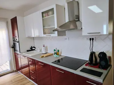 a kitchen with white cabinets and a sink at Vivere in Slovenia in Plavje
