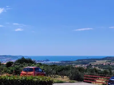 a red car parked on the side of a road at Vivere in Slovenia in Plavje
