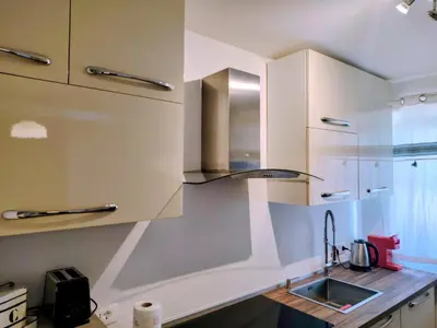 a kitchen with white cabinets and a sink at Vivere in Slovenia in Plavje