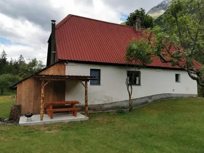 a small church with a bench in front of it at Idina domačija in Trenta