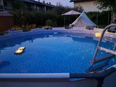 a swimming pool in a yard with a tent at CAMP THEA, Glamping tent yurtas in Rose resort in Mrše