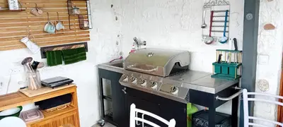a kitchen with a stove and a sink at CAMP THEA, Glamping tent yurtas in Rose resort in Mrše