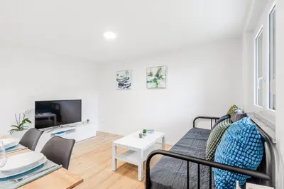 a living room with a couch and a table at Apartment SočaFly in Tolmin
