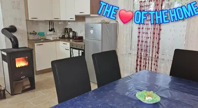 a kitchen with a table and a refrigerator with a heart sign at Cozy ap rooms 2nd floor near Capital of Slovenia in Ljubljana
