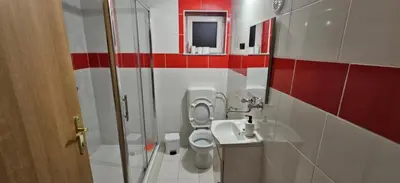 a bathroom with a toilet and a sink and a shower at Cozy ap rooms 2nd floor near Capital of Slovenia in Ljubljana