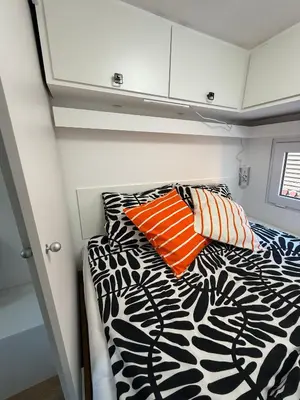 a bed with two orange and white pillows on it at Mobile House LaSiesta Thermal park Terme 3000 in Moravske Toplice