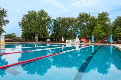 a large swimming pool with blue water at Mobile House LaSiesta Thermal park Terme 3000 in Moravske Toplice