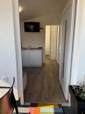 a room with a hallway with a kitchen and a television at Mobile House LaSiesta Thermal park Terme 3000 in Moravske Toplice