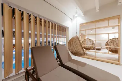 a room with two chairs and a swimming pool at Mobile House LaSiesta Thermal park Terme 3000 in Moravske Toplice