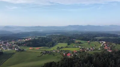 an aerial view of a village in a green field at Sunny Karla apartment Dramlje in Dramlje