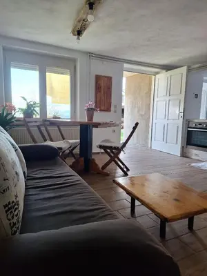 a living room with a couch and a table at Sunny Karla apartment Dramlje in Dramlje